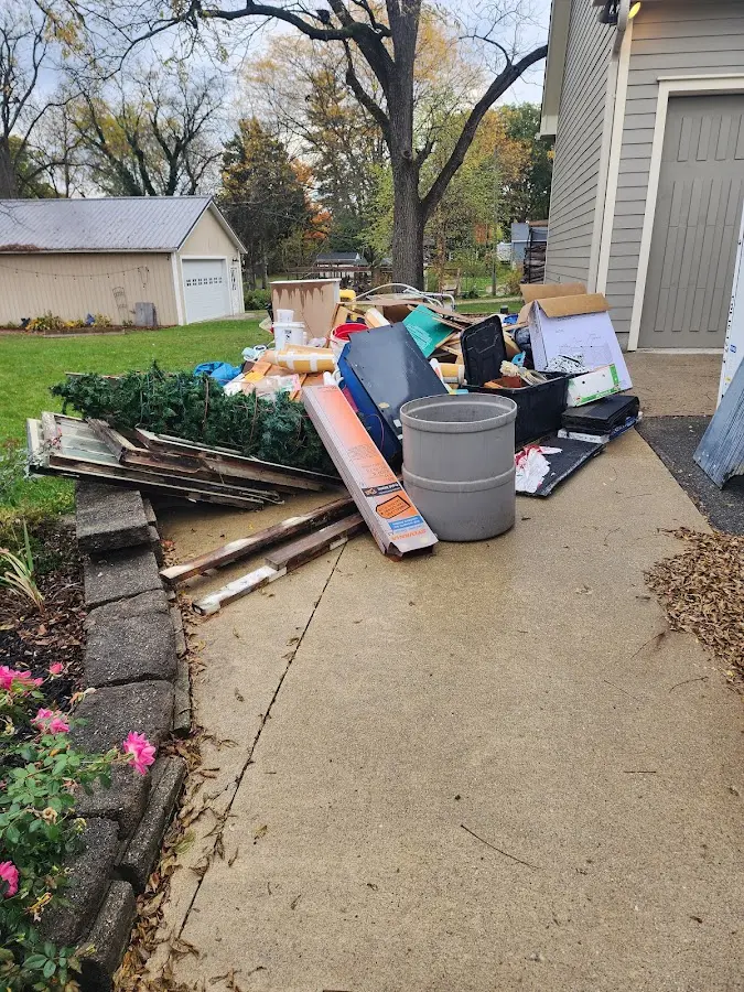 Dumpster being loaded with debris for Roofing Dumpster Rental in Hazlehurst